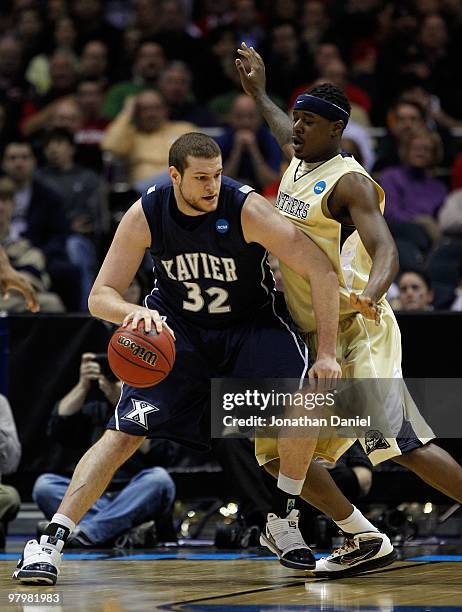 Kenny Frease of the Xavier Musketeers posts up Dante Taylor of the Pittsburgh Panthers during the second round of the 2010 NCAA men's basketball...
