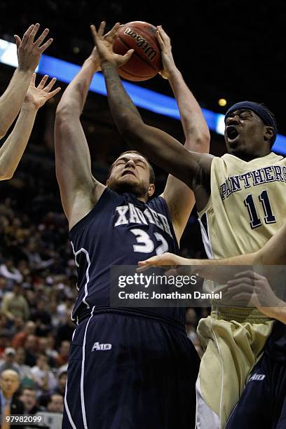 Kenny Frease of the Xavier Musketeers goes up for a shot against Dante Taylor of the Pittsburgh Panthers during the second round of the 2010 NCAA...