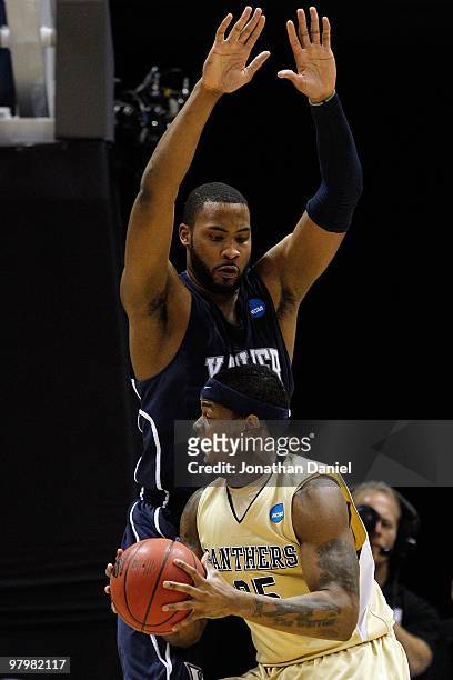 Nasir Robinson of the Pittsburgh Panthers looks to make a move on Jason Love of the Xavier Musketeers during the second round of the 2010 NCAA men's...