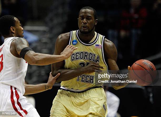 Zachery Peacock of the Georgia Tech Yellow Jackets passes the ball as he is covered by David Lighty of the Ohio State Buckeyes during the second...