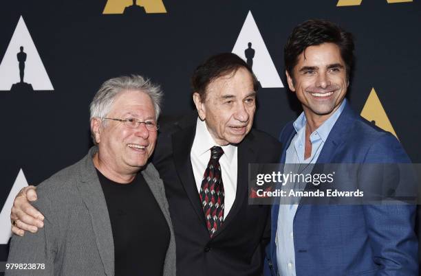 Songwriters Alan Menken and Richard M. Sherman and actor John Stamos arrive at The Academy Of Motion Picture Arts And Sciences presentation of "The...