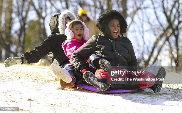 The weekend snowfall was much less than expected, but despite cold wind and frigid temperatures, adventurous sledders flocked to a hill on Ashton...