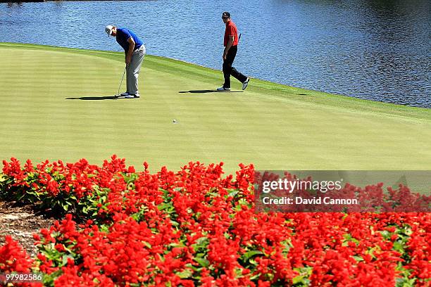 Ernie Els of South Africa and the Lake Nona Team watches his putt on the 12th hole with Nick O'Hern of Australia and the Isleworth Team watching on...