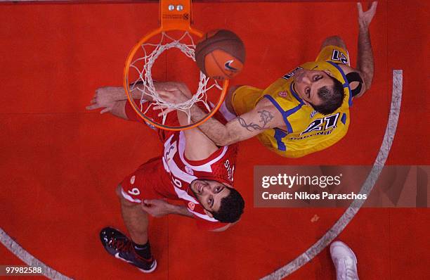 Ratko Varda, #21 of Asseco Prokom Gdynia competes with Ioannis Bourousis, #9 of Olympiacos Piraeus during the Euroleague Basketball 2009-2010 Play...