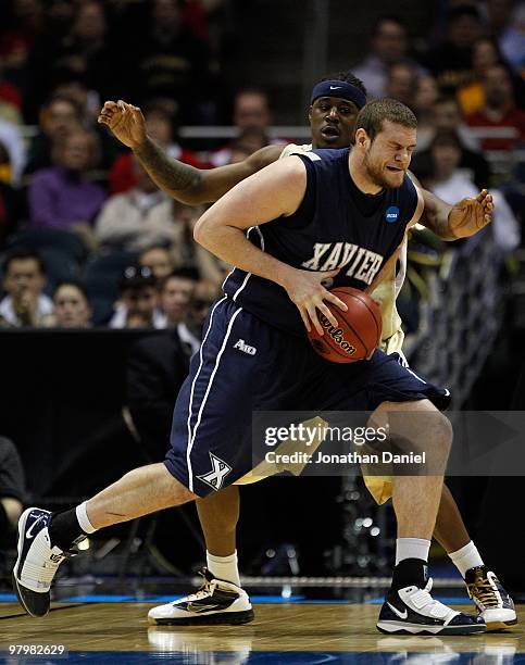 Kenny Frease of the Xavier Musketeers posts up Dante Taylor of the Pittsburgh Panthers during the second round of the 2010 NCAA men's basketball...