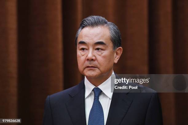 China's Foreign Minister Wang Yi waits for Denmark's Foreign Minister Anders Samuelsen to arrive for a meeting at the Foreign Ministry in Beijing on...