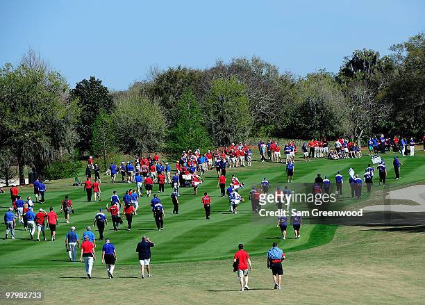Crowds walk down the 18th hole during the second day's play of the Tavistock Cup at Isleworth Golf and Country Club on March 23, 2010 in Orlando,...