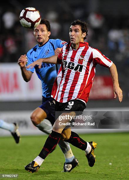 Mauro Boselli of Argentina's Estudiantes fights for the ball with Ronald Rivero of Bolivia's Bolivar during their 2010 Copa Libertadores soccer match...