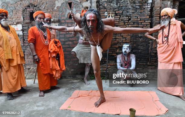 An Indian sadhu -- Hindu holy man -- performs yoga to mark International Yoga Day at Kamakhya Temple in Guwahati in the Indian state of Assam on June...