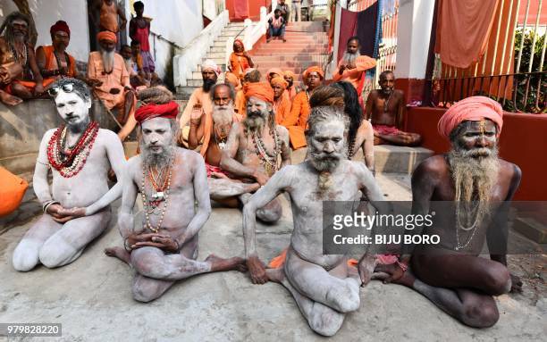 Indian sadhus -- Hindu holy men -- perform yoga to mark International Yoga Day at Kamakhya Temple in Guwahati in the Indian state of Assam on June...