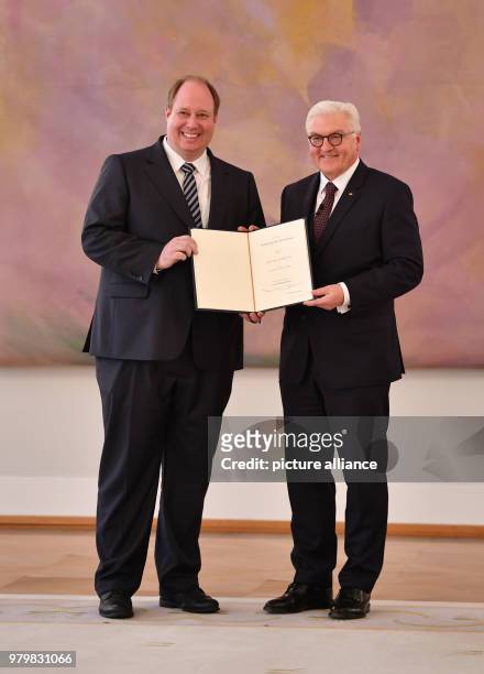 Dpatop - German President Frank-Walter Steinmeier presents a certificate of appointment to Helge Braun , head of the German chancellery, during the...