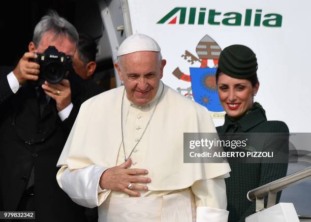 Pope Francis boards a plane to fly from the Fiumicino airport on June 21 to Geneva for a one day pastoral trip.