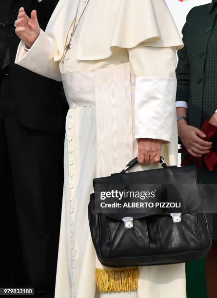Pope Francis waves as he board his plane to fly from the Fiumicino airport on June 21 to Geneva for a one day pastoral trip.