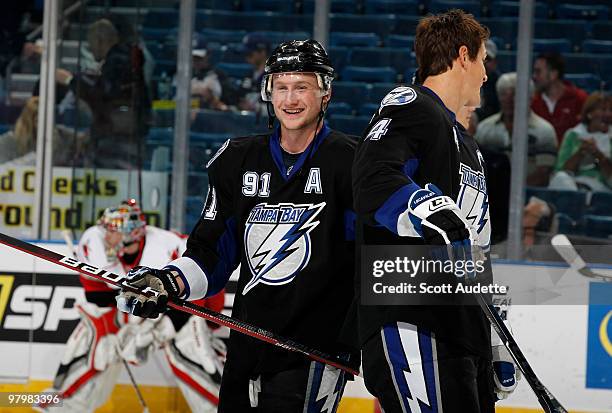 Steven Stamkos of the Tampa Bay Lightning talks with teammate Vincent Lecavalier during pregame warmup against the Carolina Hurricanes at the St....