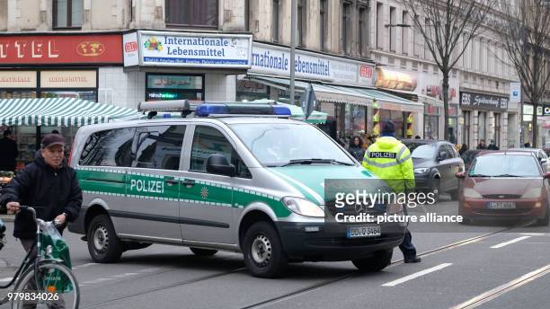 March 2018, Germany, Leipzig: A police car blocks the traffic on Leipzig's Eisenbahnstrasse during a police operation against drug-related and...