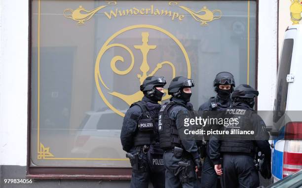 Dpatop - 14 March 2018, Germany, Leipzig: SWAT police officers stand in front of a shop on Leipzig's Eisenbahnstrasse during a large scale police...