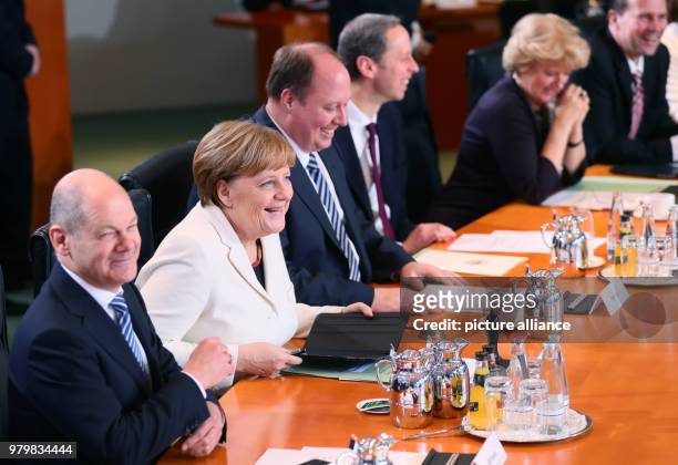 Dpatop - German Chancellor Angela Merkel of the Christian Democratic Union , German Minister of Finance Olaf Scholz of the Social Democratic Party ,...