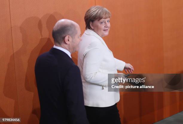 German Chancellor Angela Merkel of the Christian Democratic Union and German Minister of Finance Olaf Scholz of the Social Democratic Party attend...