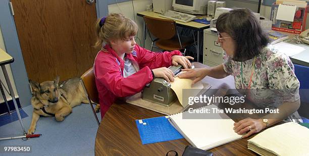 Blind- Maryland School for The Blind, celebrating its 150th year and a new president. Braille teacher Carol Gamble, right, as guide dog Teka waits...