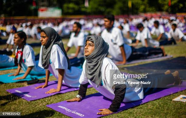 Kashmiri students perform Yoga in a stadium on June 21 in Srinagar, the summer capital of Indian administered Kashmir, India. Yoga, which means union...
