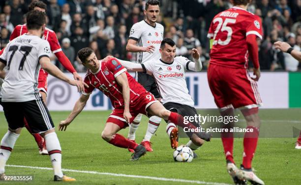 Bayern's Robert Lewandowski and Besiktas' Gary Medel battle for the ball during the UEFA Champions League round of 16 second leg soccer match between...