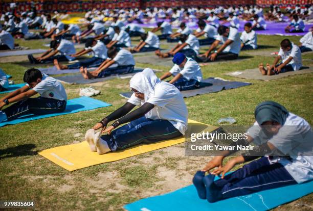 Kashmiri students perform Yoga in a stadium on June 21 in Srinagar, the summer capital of Indian administered Kashmir, India. Yoga, which means union...