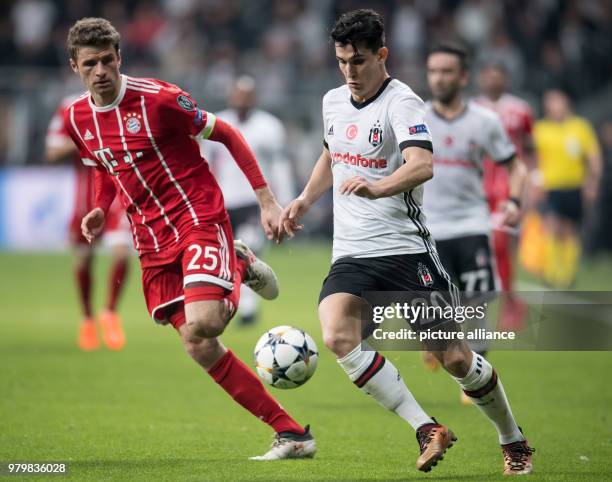 Dpatop - Bayern's Thomas Mueller and Besiktas' Necip Uysal vie for the ball during the UEFA Champions League round of 16 second leg soccer match...