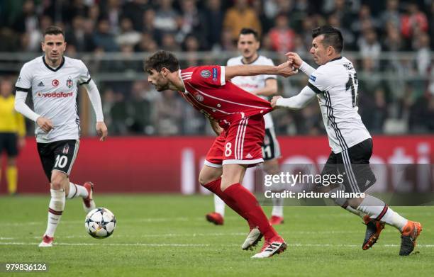 Dpatop - Bayern's Javi Martinez and Besiktas' Gary Medel vie for the ball during the UEFA Champions League round of 16 second leg soccer match...