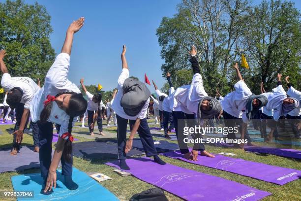 School girls participate in an outdoor yoga session to mark International Yoga Day in Srinagar, Indian administered Kashmir. Hundreds of Yoga...
