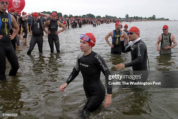 Swim- Cari Parven writes about her swim in the Chesapeake Bay swim. Parven, center, and other swimmers test the water before the start. By James M...