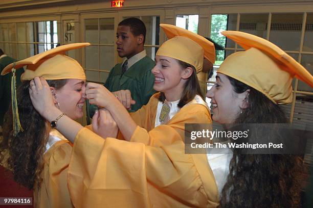Grad- Montgomery County's John F. Kennedy HS graduation at DAR Constitution Hall. Daniella Anna Schmidt, left, gets her nose tweeked by Laurel Grace...