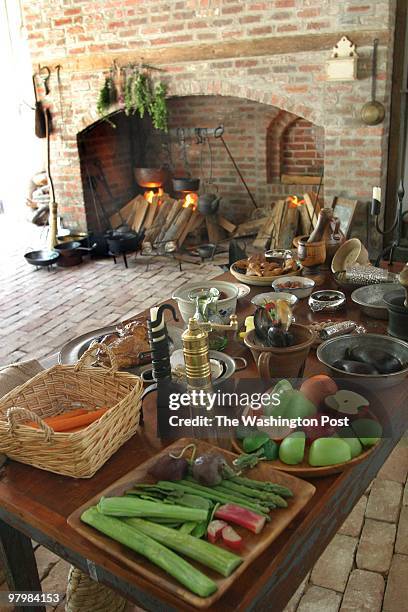 Kitchen- New colonial kitchen display in the Carriage House of the Montpelier House in Laurel. This is the kithen fireplace and table with props. By...