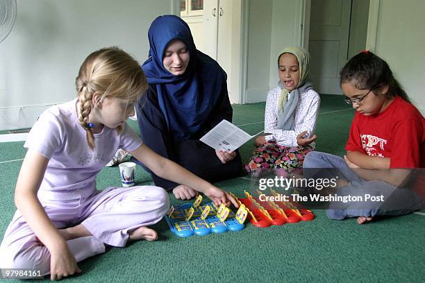 Muslim-A summer camp held by Columbia Mosque. Some of the girls playing a game, LTR, Tasneen Qualawee teacher Chancey Gannett, Rokia Hassanenin and...