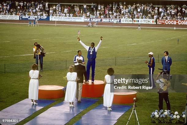 Carl Lewis celebrates on the podium after winning the Men's Long Jump during the 1983 World Championships in Athletics on August 10, 1983 in...