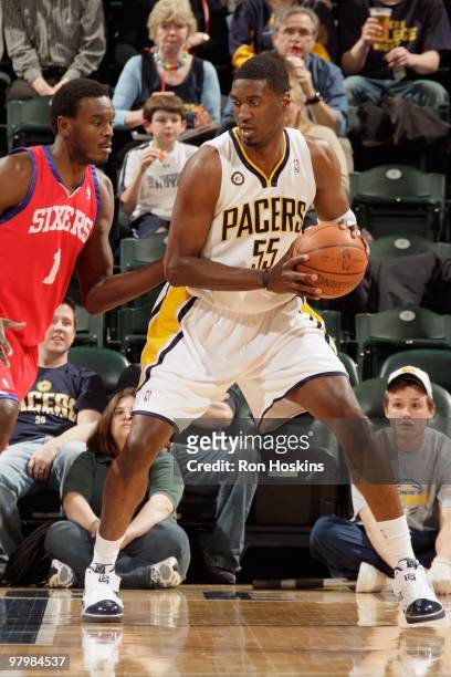 Roy Hibbert of the Indiana Pacers handles the ball against Samuel Dalembert of the Philadelphia 76ers during the game on March 9, 2010 at Conseco...