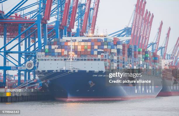 March 2018, Germany, Hamburg: The container ship "Antoine de Saint Exupery" of the "CMA CGM" shipping line lying at anchor in the Burchard-Kai...