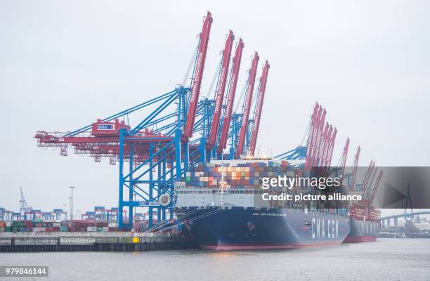 March 2018, Germany, Hamburg: The container ship "Antoine de Saint Exupery" of the "CMA CGM" shipping line lying at anchor in the Burchard-Kai...