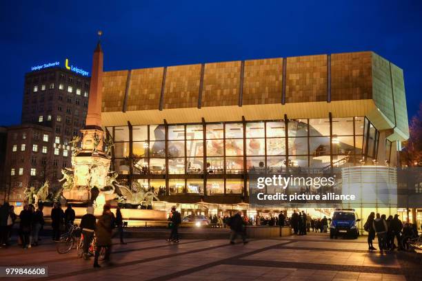 March 2018, Germany, Leipzig: The Gewandhaus concert hall and the Mende Fountain are illuminated in the evening. The lettering '275 Jahre Gewandhaus...