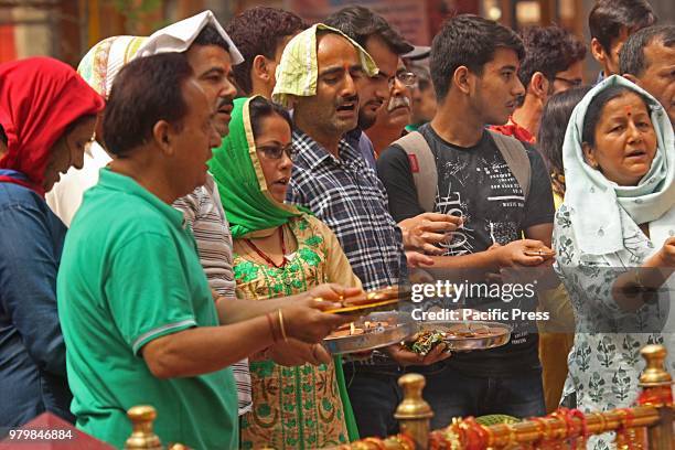 Devotees assemble to pray during the annual Hindu festival at the Kheer Bhawani Temple at Tullamulla Ganderbal, some 28 kilometers from Srinagar the...