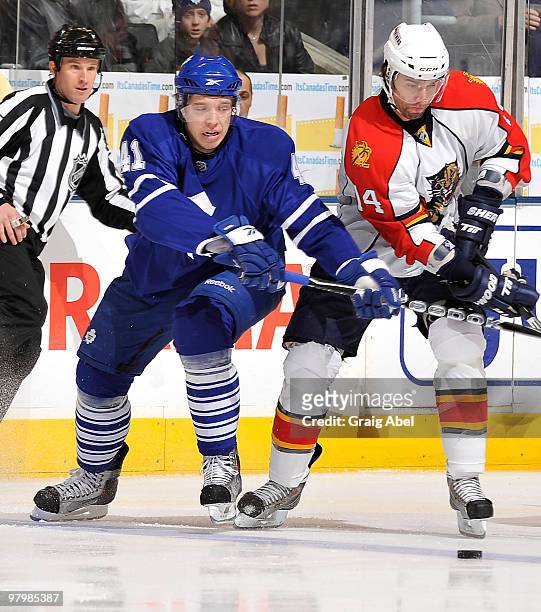 Nikolai Kulemin of the Toronto Maple Leafs battles for the puck with Radek Dvorak of the Florida Panthers during game action March 23, 2010 at the...