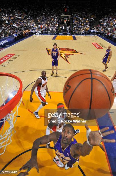 Ron Artest of the Los Angeles Lakers shoots a layup against Corey Maggette of the Golden State Warriors during the game at Oracle Arena on March 15,...