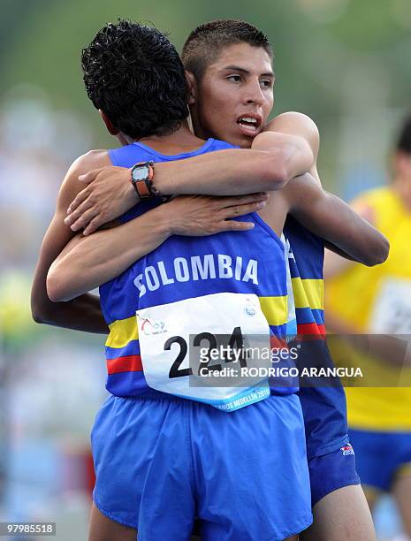 Colombian Mauricio Gonzalez and Colombian Javier Pena celebrate after winning the gold and silver medals respectively in the men's 5000 m, during the...