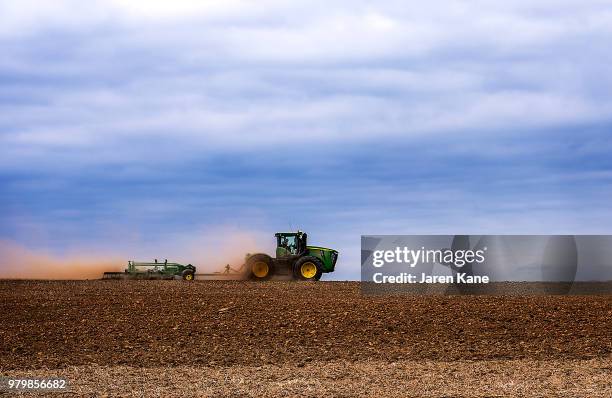 spring beginnings - tractor ploughing field bildbanksfoton och bilder