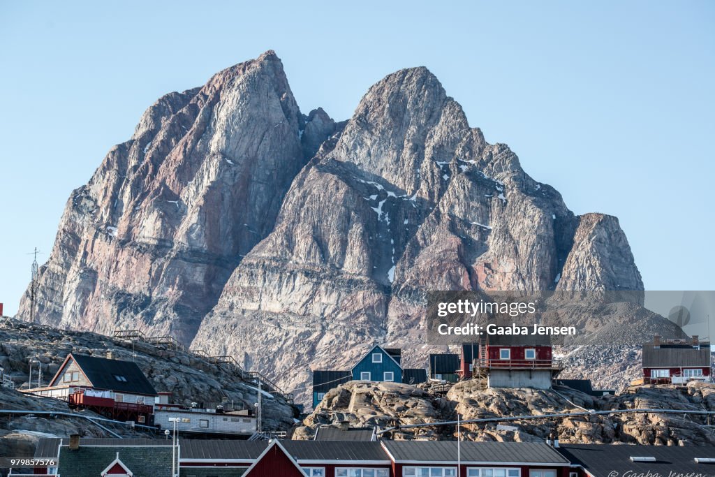 Town with mountain in background, Uummannaq, Greenland