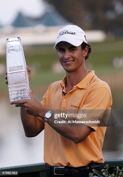 Adam Scott hoists the winner's trophy after final-round play at the PGA Tour's Players Championship March 28, 2004.