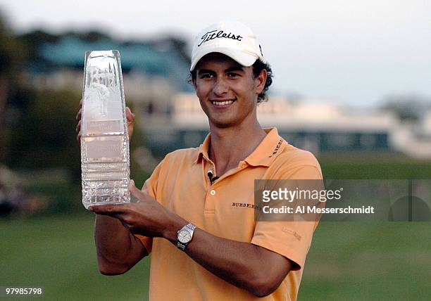 Adam Scott hoists the winner's trophy after final-round play at the PGA Tour's Players Championship March 28, 2004.