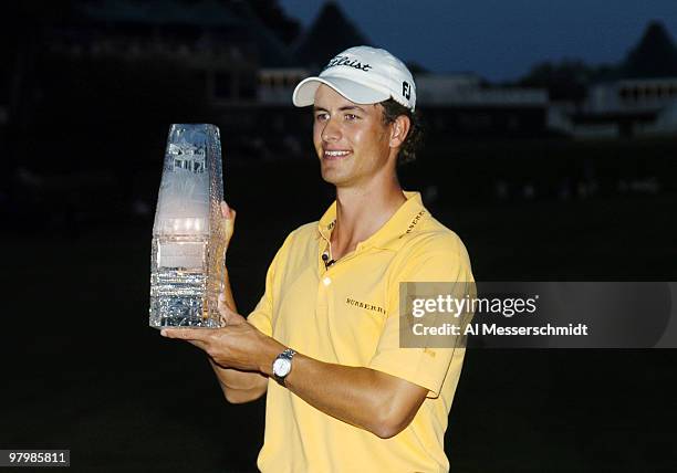 Adam Scott hoists the winner's trophy after final-round play at the PGA Tour's Players Championship March 28, 2004.