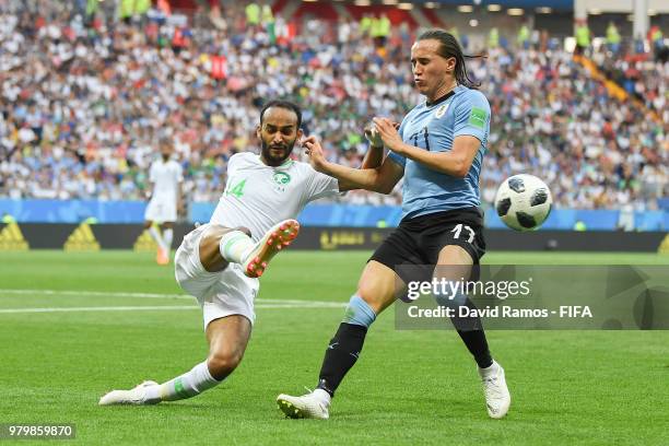 Diego Laxalt of Uruguay competes for the ball with Abdullah Otayf of Saudi Arabia during the 2018 FIFA World Cup Russia group A match between Uruguay...