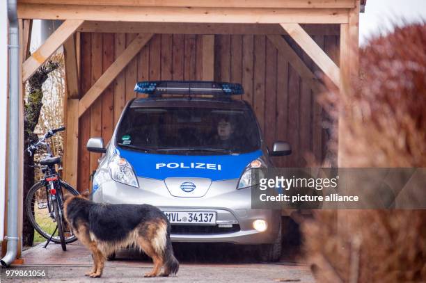 March 2018, Germany, Hiddensee: Island police officer Martina Dominik sitting in her electric patrol car while her German Shepherd dog, Maggie,...