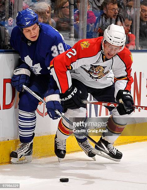 John Mitchell of the Toronto Maple Leafs battles for the puck with Keith Ballard of the Florida Panthers during game action March 23, 2010 at the Air...